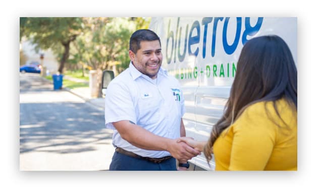 A bluefrog Plumbing + Drain plumber greeting a customer