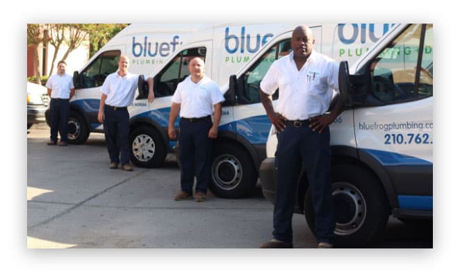 The bluefrog Plumbing + Drain team beside a service van