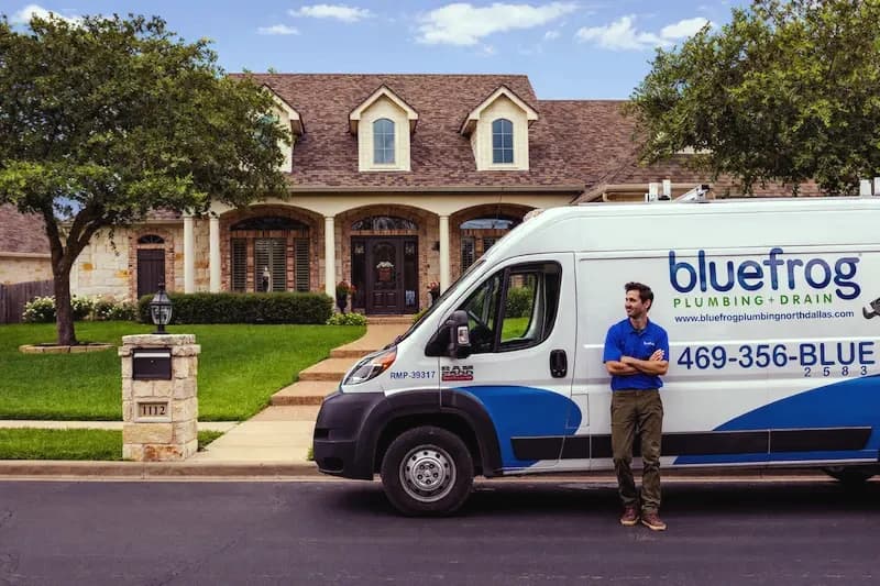 A bluefrog Plumbing + Drain van parked outside a customer’s home