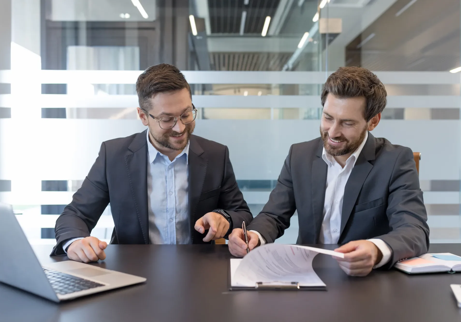 Two business people reviewing loan paperwork